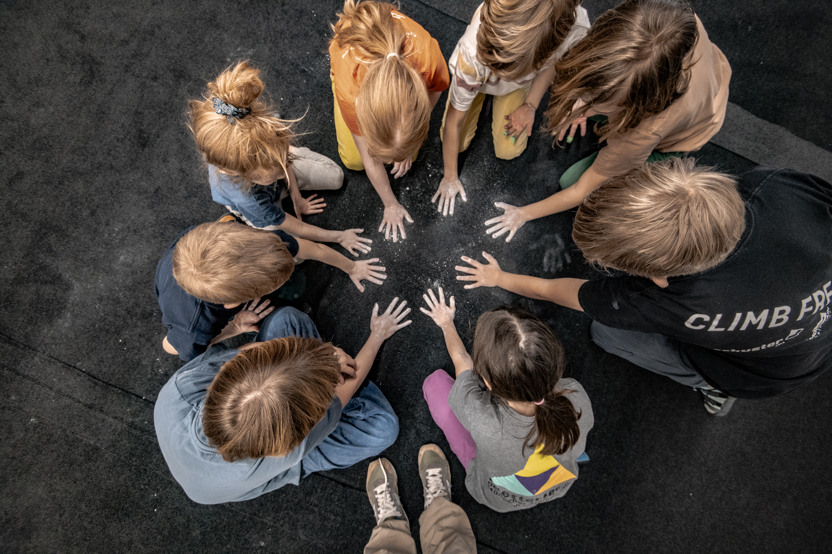 Kindergruppe macht Abdrücke ihrer Hände auf die Matte mit Chalk